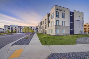 modern apartment buildings on a city street with a sidewalk