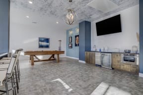 a game room with a pool table and a tv