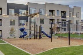 a playground in front of an apartment building