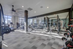 a gym with weights and cardio equipment in a building