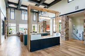 A reception area with a wooden counter and a staircase.