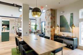 A conference room with a long table and chairs.