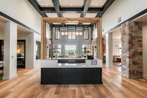 A modern interior with a reception desk and a stone pillar.