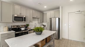 a kitchen with stainless steel appliances and a marble counter top