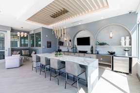 a large kitchen with a marble counter top and a dining table