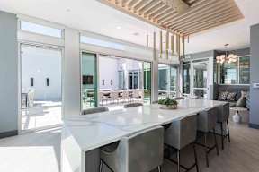 a large dining room with a long white table and chairs