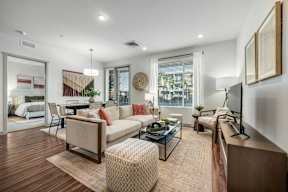 A modern living room with a sofa, chair, and coffee table at Bask Deer Valley apartments for rent in Phoenix, AZ.