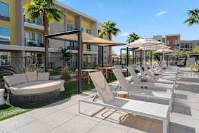 A sunny day at the outdoor seating area of a modern apartment complex.