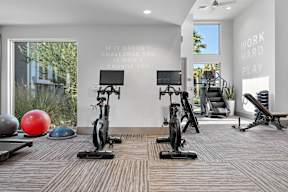 A gym with a motivational quote on the wall.