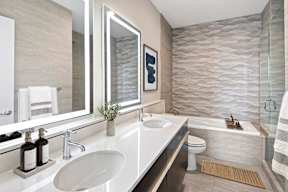 A bathroom with a white sink and a mirror above it.