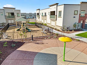 an empty playground in the middle of an apartment complex