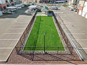 a grass field in the middle of a parking lot