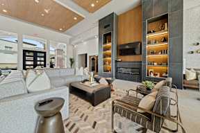a living room with couches and chairs and a fireplace