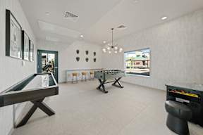 a game room with two shuffleboards and a foosball table