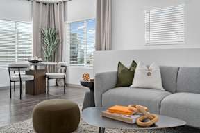 a living room with a gray couch and a coffee table