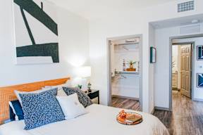 a bedroom with a bed and a door to a bathroom