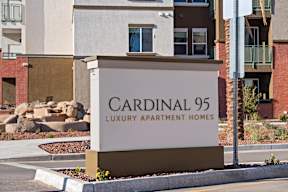 a sign for cardinal 95 luxury apartment homes in front of a building