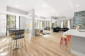 A modern living room with a bar area and a kitchen in the background.