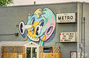 a mural on the side of a building with a music hall sign