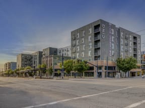 an empty street in front of an apartment building