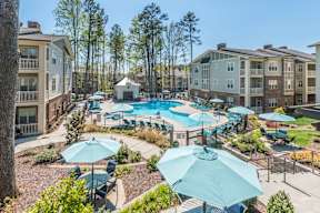 Aerial view of the pool surrounded by lounge chairs at The Everlin at Indian Trail apartments in Indian Trail, NC.