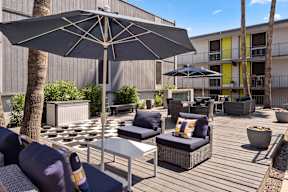Outdoor lounge area with chairs at Crosstown Phoenix apartments.