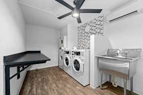 a laundry room with a sink and washer and dryer