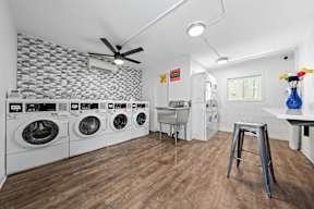 a laundry room with washer and dryer and a sink