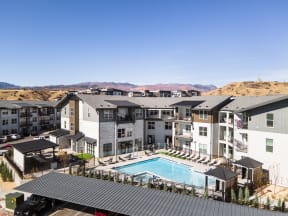 an aerial view of an apartment complex with a swimming pool