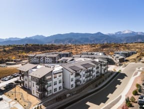 an aerial view of an apartment complex with mountains in the background