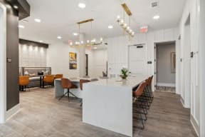 a communal area with a large white table and chairs in a lobby