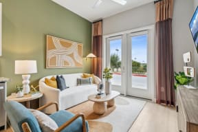 a living room with a white couch and a sliding glass door