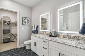 a bathroom with a sink and a toilet and a mirror