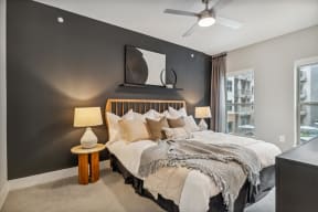 a bedroom with a large bed and a ceiling fan