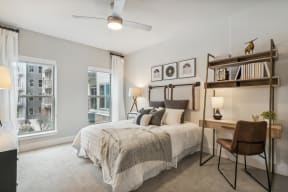a bedroom with a bed and a large window