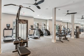 a gym with cardio machines and other exercise equipment in a building