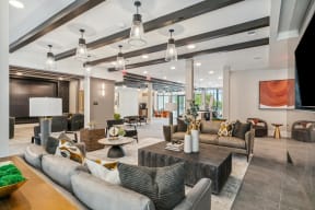 the lobby of a clubhouse with couches and tables