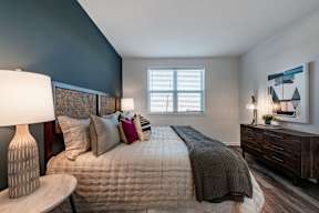 A bedroom with a bed, nightstand, and a painting on the wall. at Brandywine Green, Brandywine