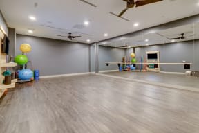 Yoga room with a mirrored wall and a large mirror on top of it