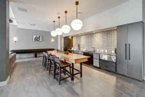 a kitchen with a long wooden table and chairs