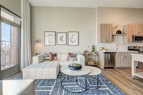 Model living room with partial kitchen and patio view  at Novus, Colorado, 80124