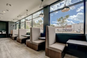 a seating area with chairs and a table in front of a window