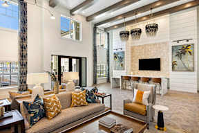 A living room with a couch, chairs, and a fireplace.