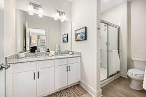 A bathroom with a white toilet and a white sink.