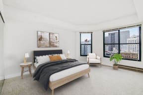 a bedroom with a bed and a large window