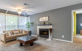 Living room with fireplace at Greenhouse Apartments, Kennesaw