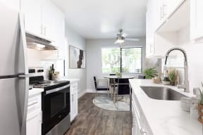 Apartments for Rent in Pleasonton, CA - Civic Square - Kitche with Quartz Countertop, Stainless-Steel Appliances, and White Modern Cabinets
