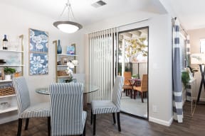 Apartments for Rent in Pleasanton - Civic Square - Living Room Area with Grey Couch, Circle Coffee Table, and Entrance to Patio