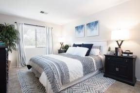 Two-Bedroom Apartments in Pleasanton, CA - Civic Square - Bedroom with Spacious Closet, Comfortable Bed, and Entrance to Bathroom