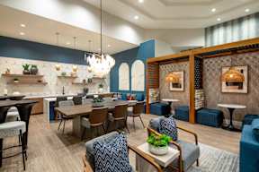 A modern dining room with a wooden table and chairs.
